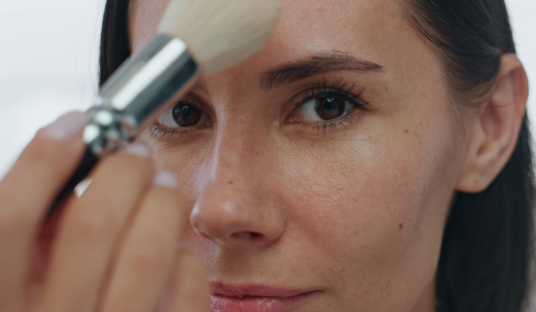 Pov morning girl makeup routine indoors. Portrait woman applying powder alone